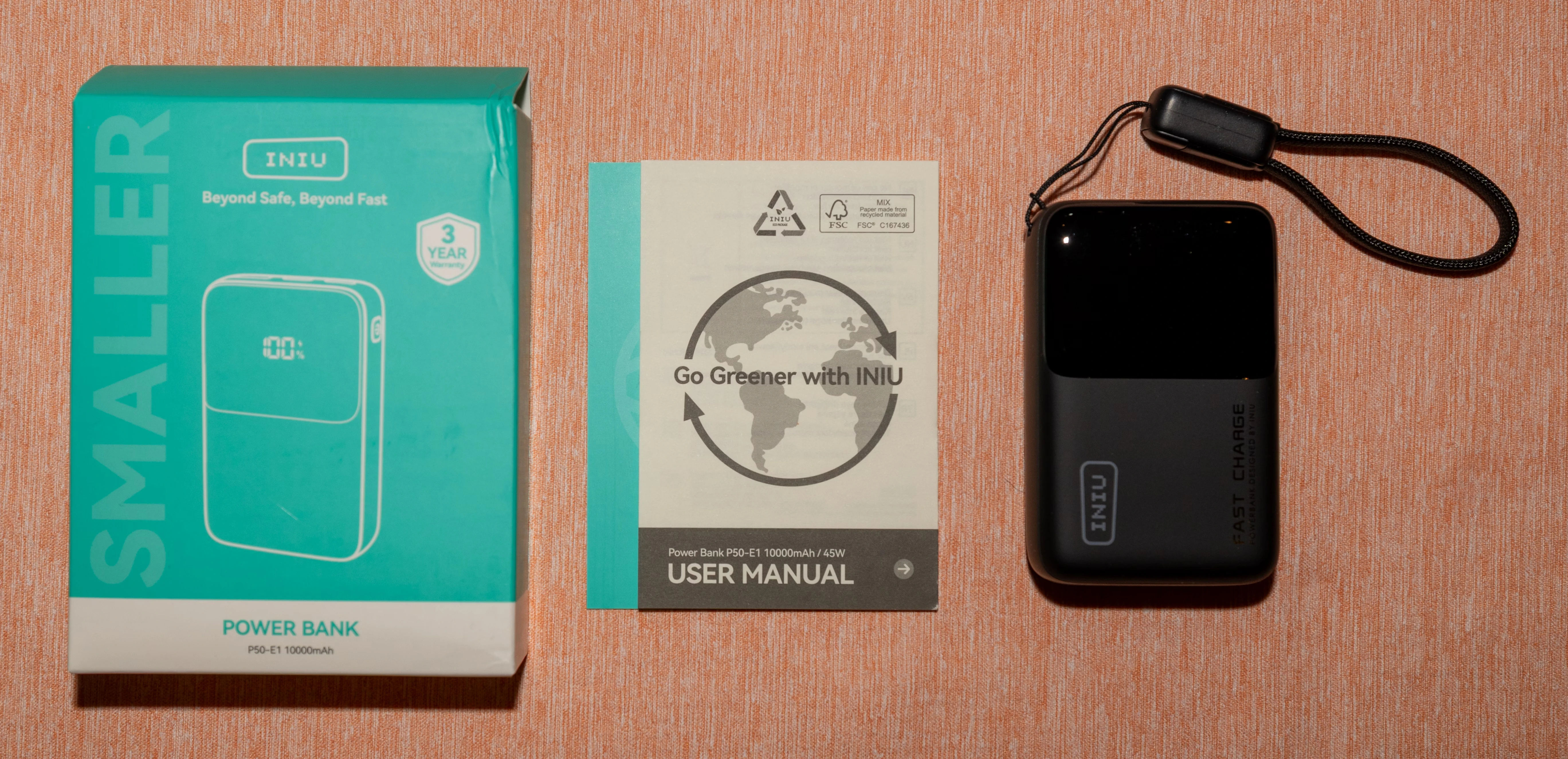 A photo of the box, included documentation and power bank with accessories