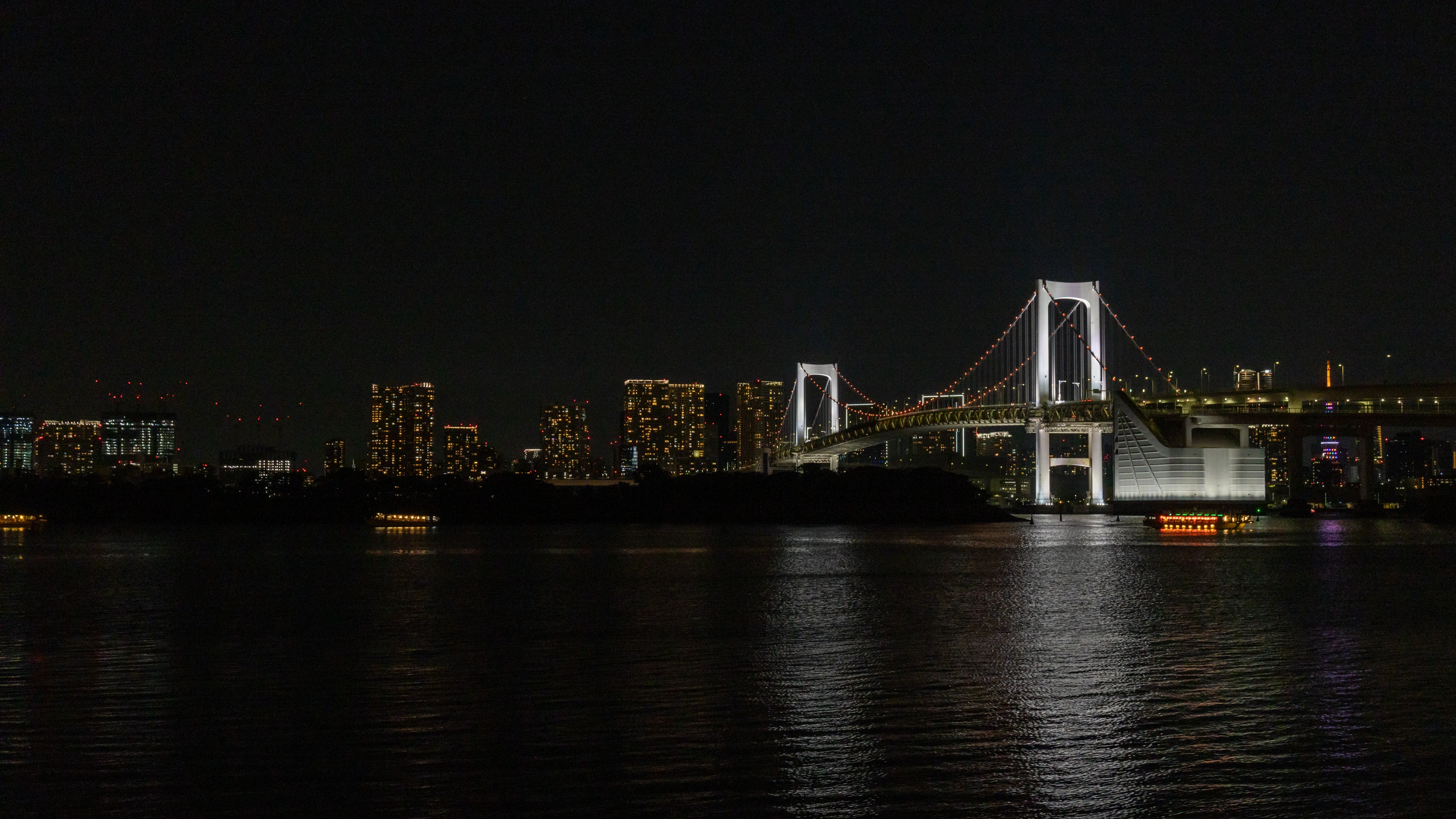 A photo of Tokyo and Rainbow Bridge, from Odaiba beach