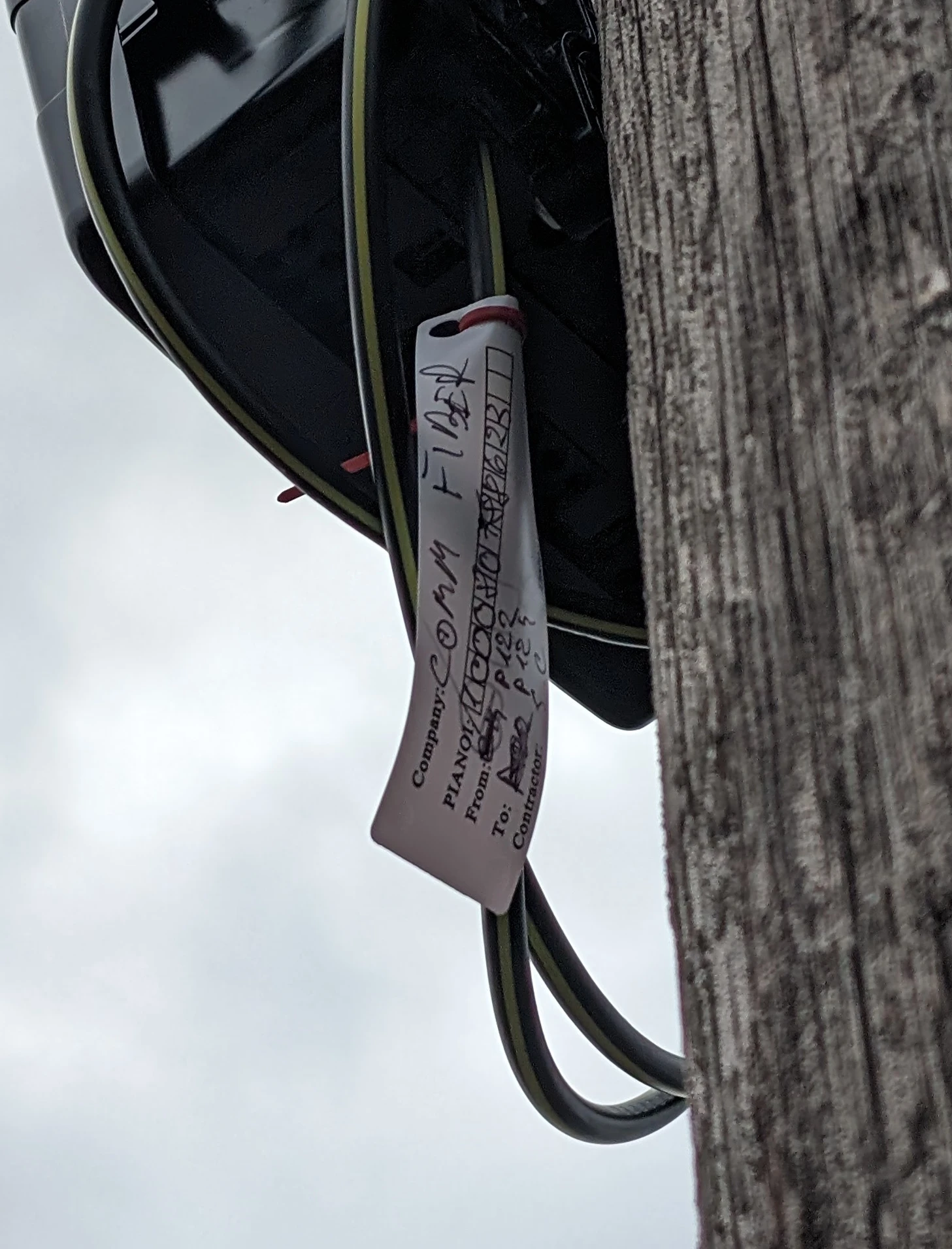 A label on one of the aerial fibre nodes stating ‘COMM FIBER (sic)’.