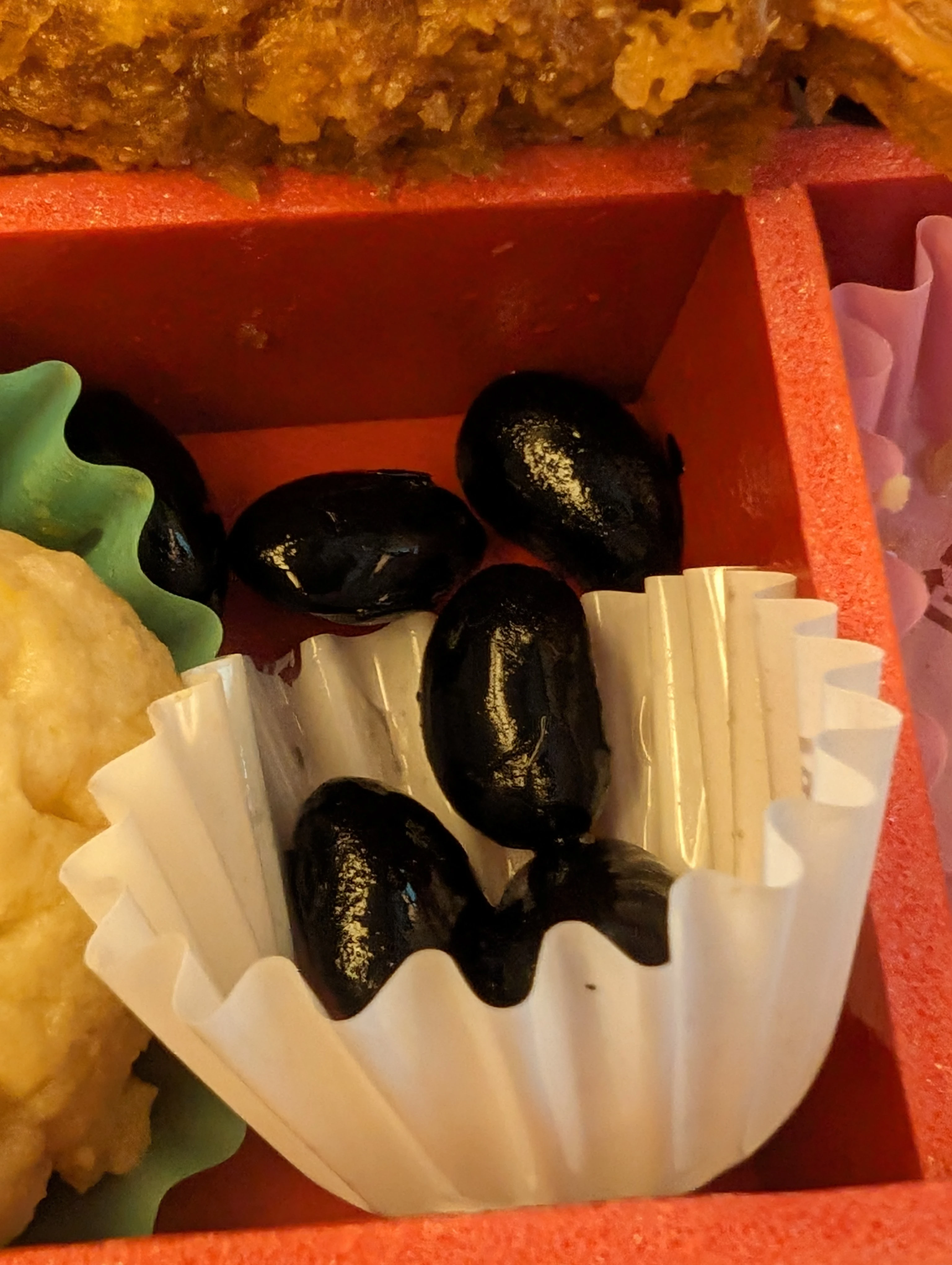 A close-up of kuromame beans in the bento box