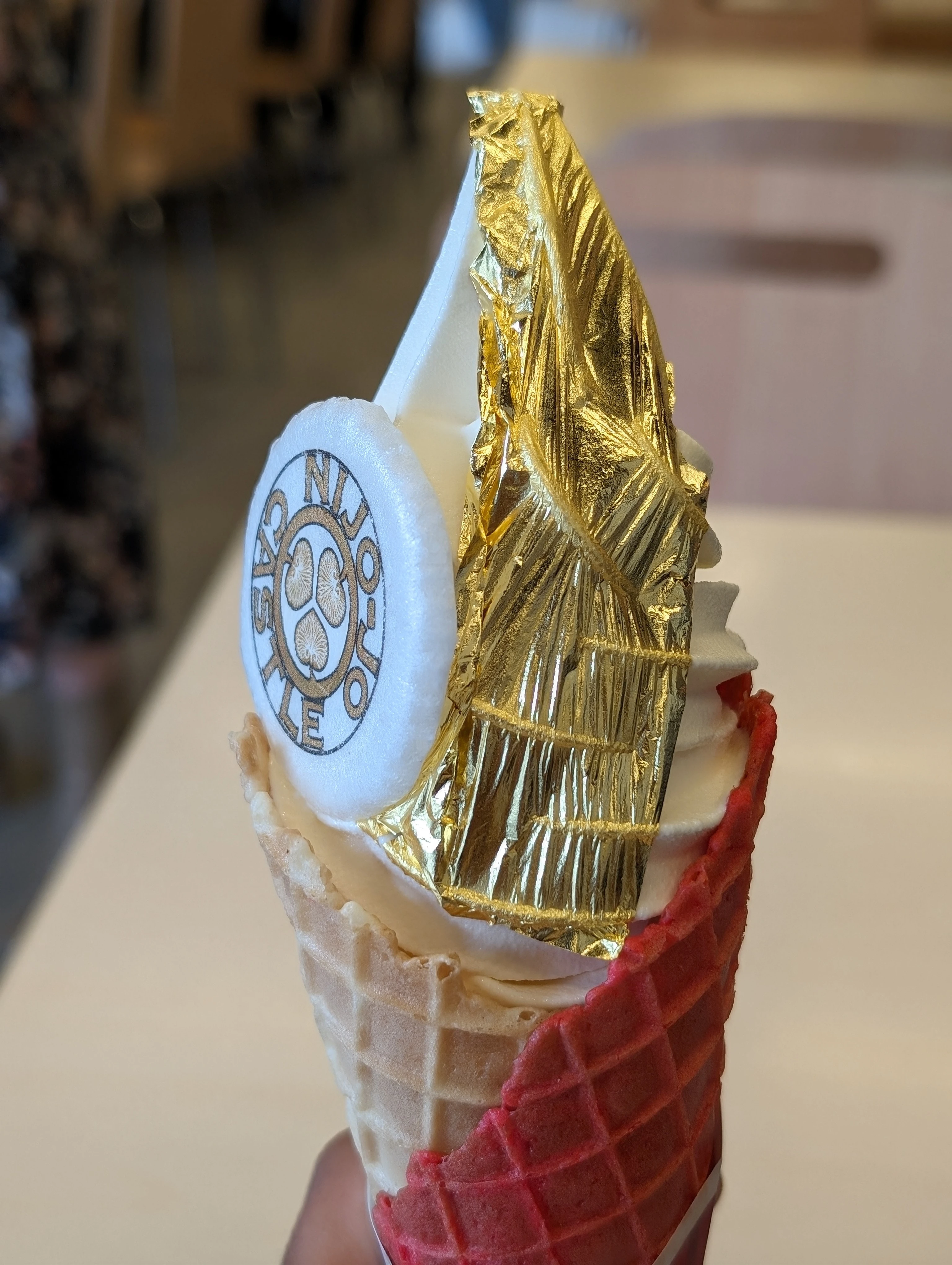 Ice cream in a cone with a gold leaf decoration