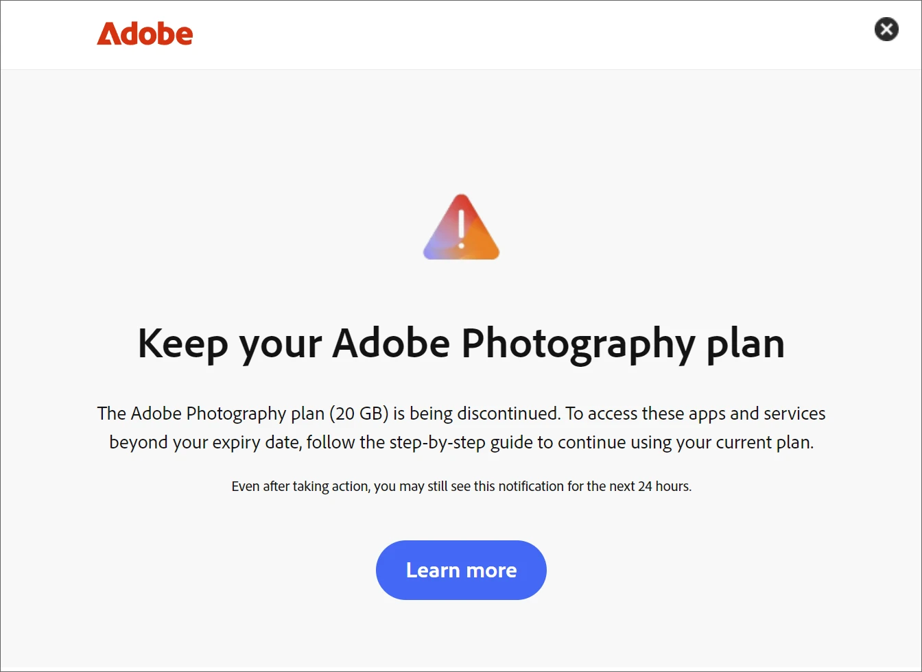 A dialogue box with heading ‘Keep your Adobe Photography plan’, message ‘The Adobe Photography plan (20 GB) is being discontinued. To access these apps and services beyond your expiry date, follow the step-by-step guide to continue using your current plan. Even after taking action, you may still see this notification for the next 24 hours.’ and a ’Learn more’ button.